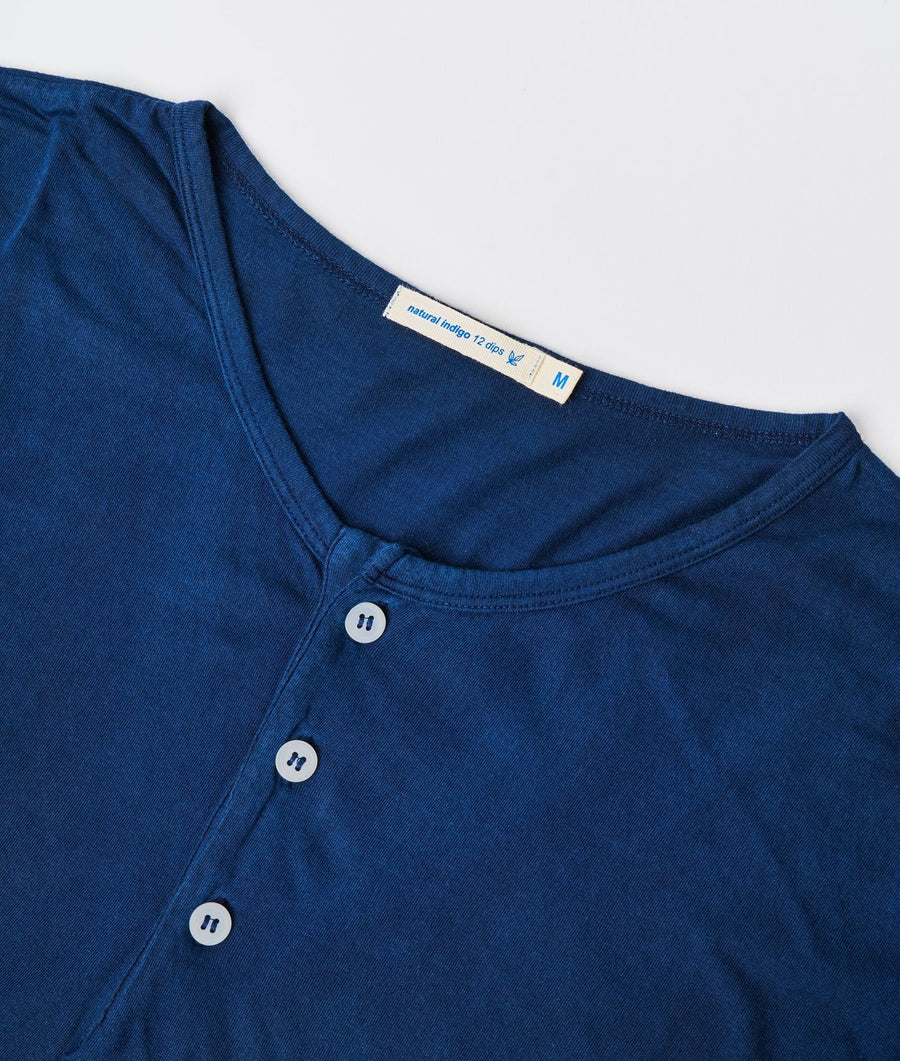 Detail shot of a navy blue organic cotton tee-shirt with simple white buttons - Industry of All Nations