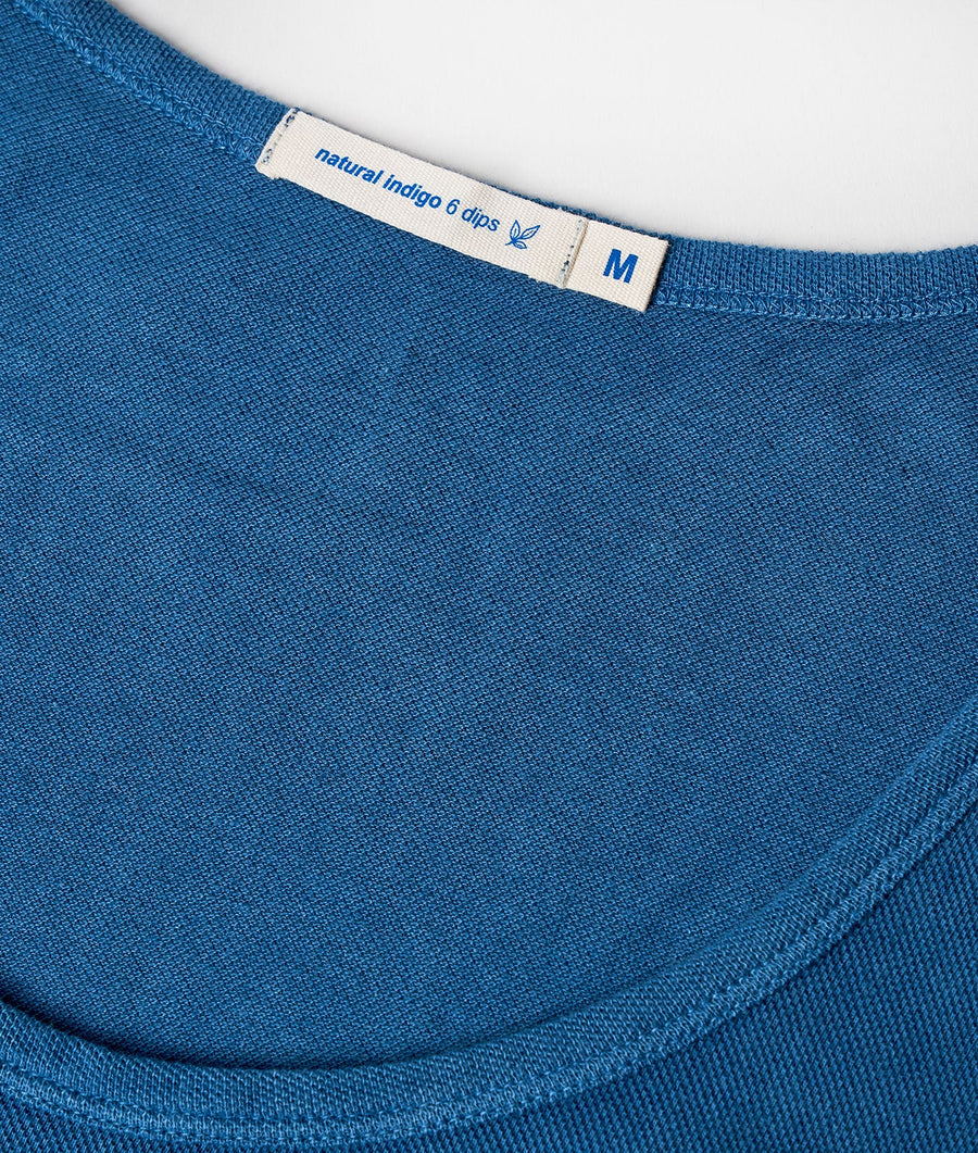 Blue cotton t-shirt with "natural indigo 6 dips" label shown in close-up detail - Industry of All Nations