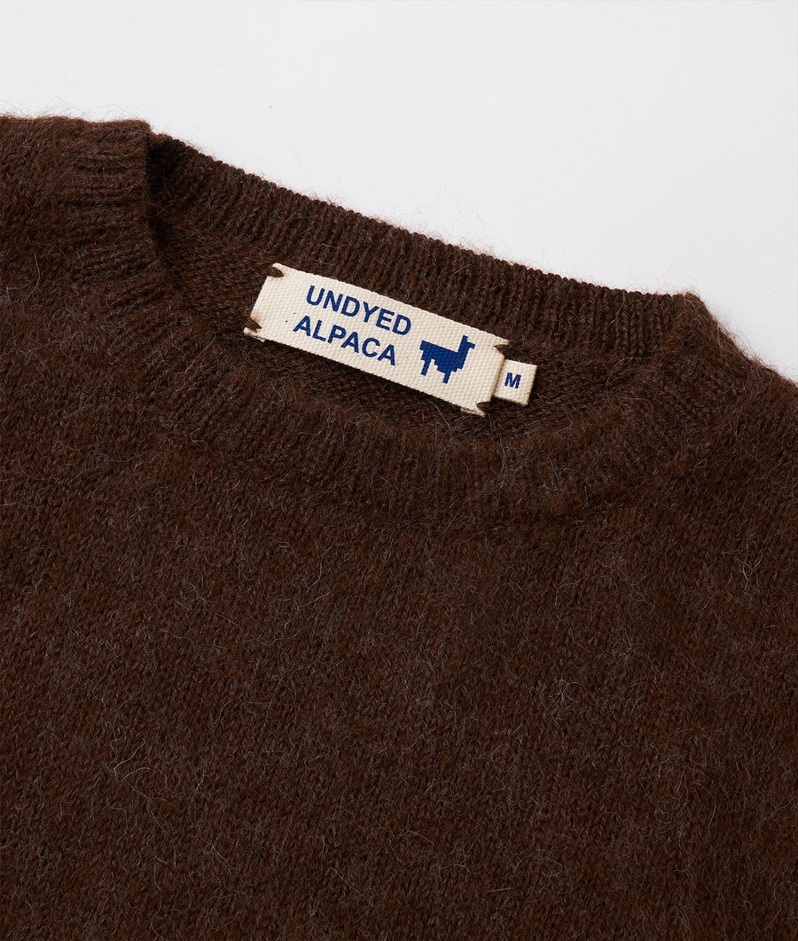 Detail shot of a brown Undyed Alpaca sweater garment label - Industry of All Nations
