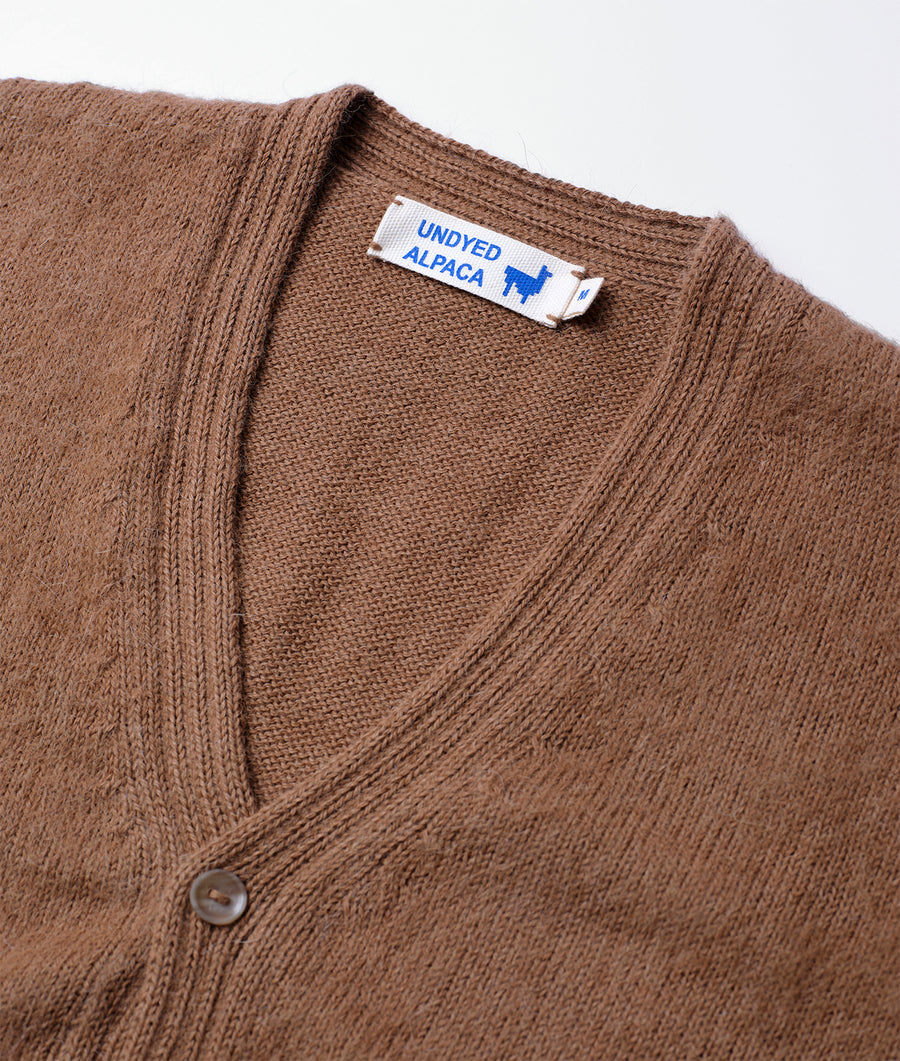 Close-up detail shot of a brown undyed alpaca cardigan with "Undyed Alpaca" label - Industry of All Nations
