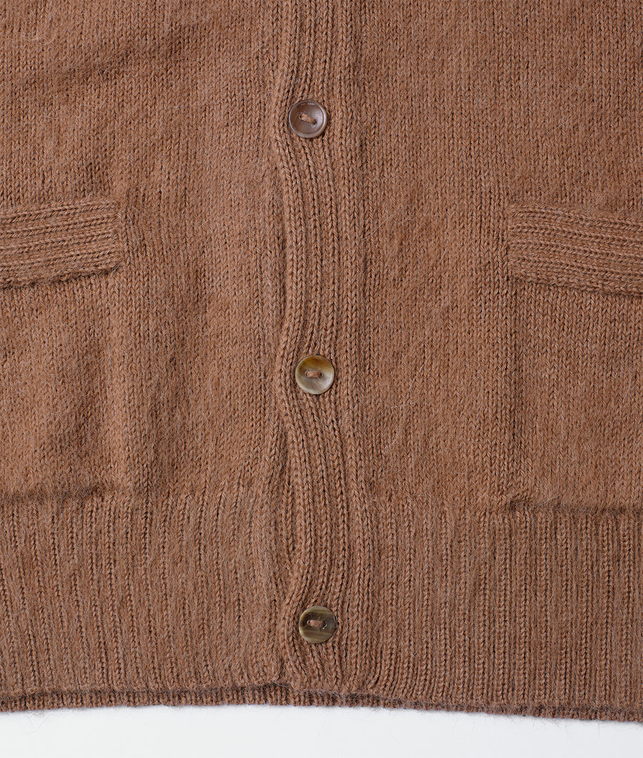 Close-up of a brown knit cardigan with buttons - Industry of All Nations