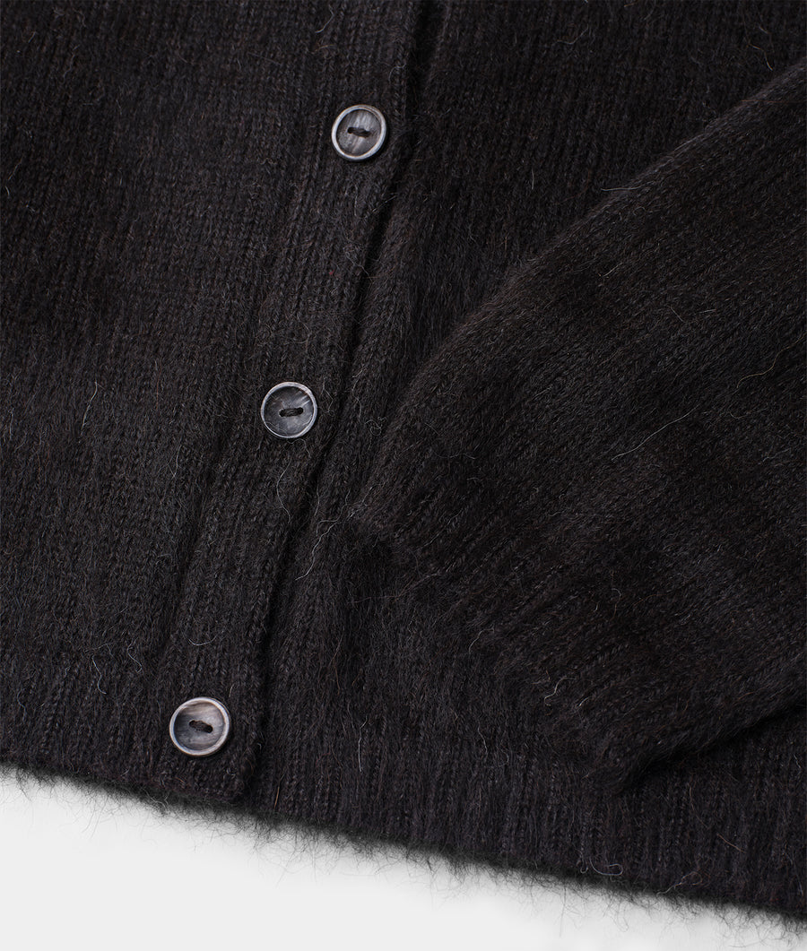 Detail shot of a black woolen button-down jacket with metal buttons - Industry of All Nations