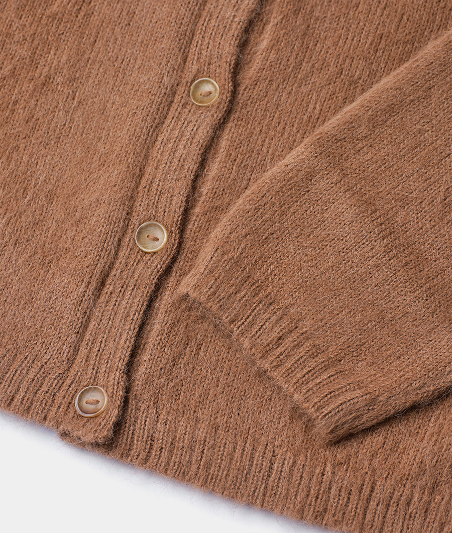 Close-up detail shot of a brown knitted cardigan with buttons - Industry of All Nations