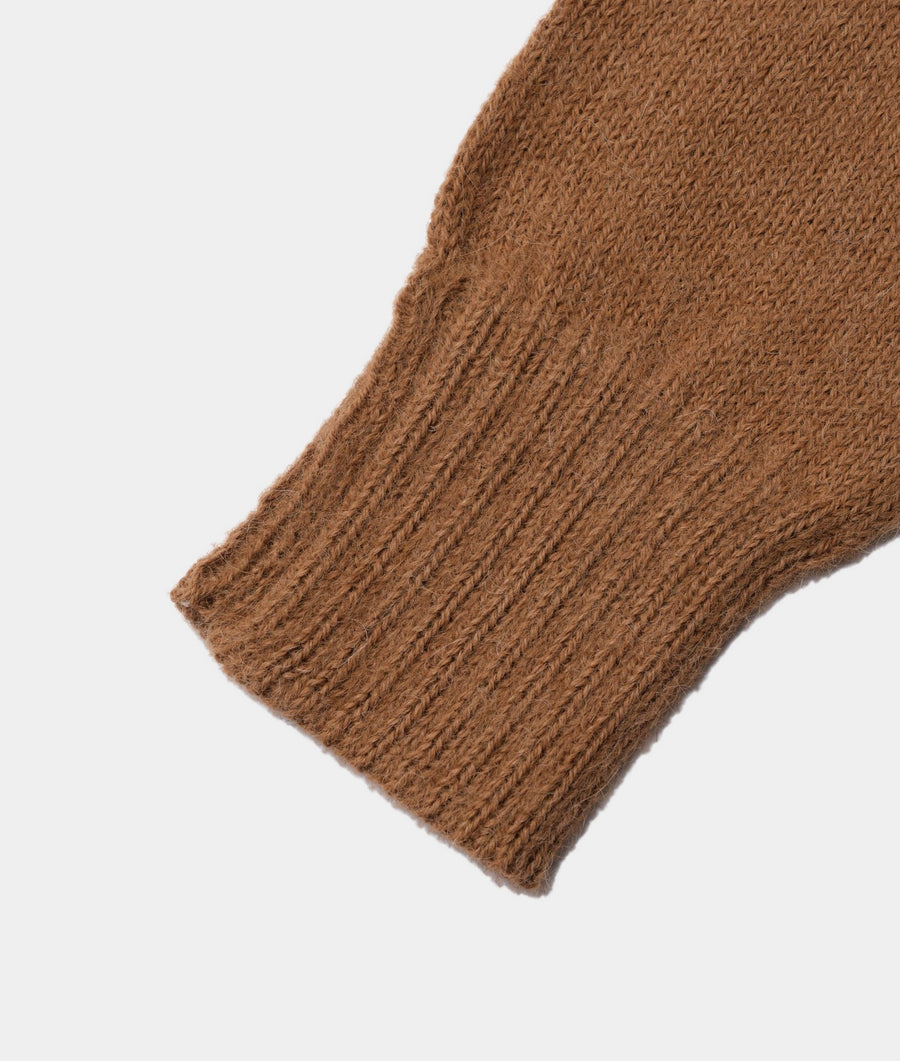 Close-up detail shot of a tan, ribbed knit sweater sleeve - Industry of All Nations