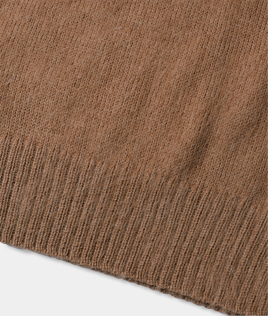 Close-up detail shot of a brown, textured organic cotton sweater from Industry of All Nations.