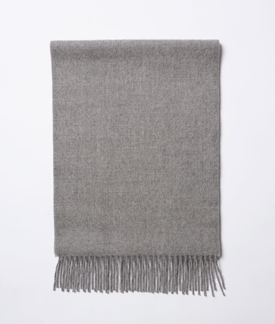 A gray wool throw blanket with fringe displayed in a flat lay style - Industry of All Nations