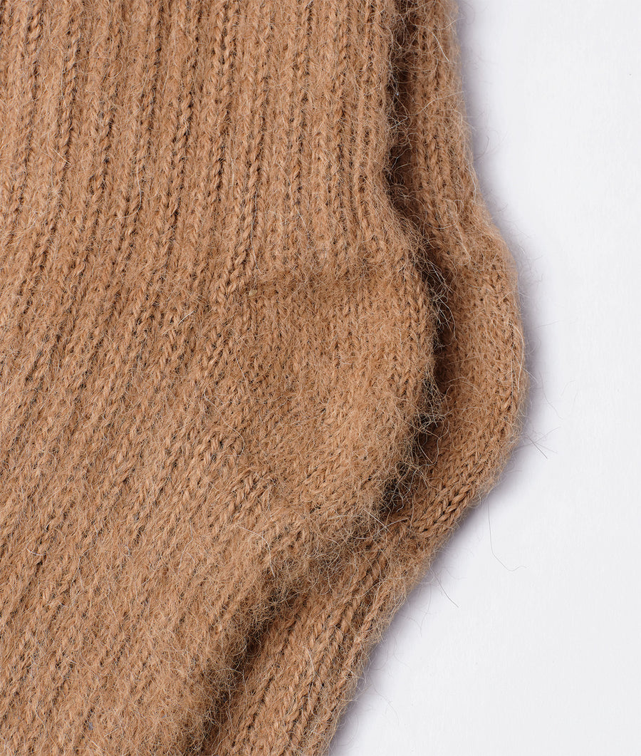 Tan-colored knit scarf or shawl displayed in a close-up detail shot - Industry of All Nations