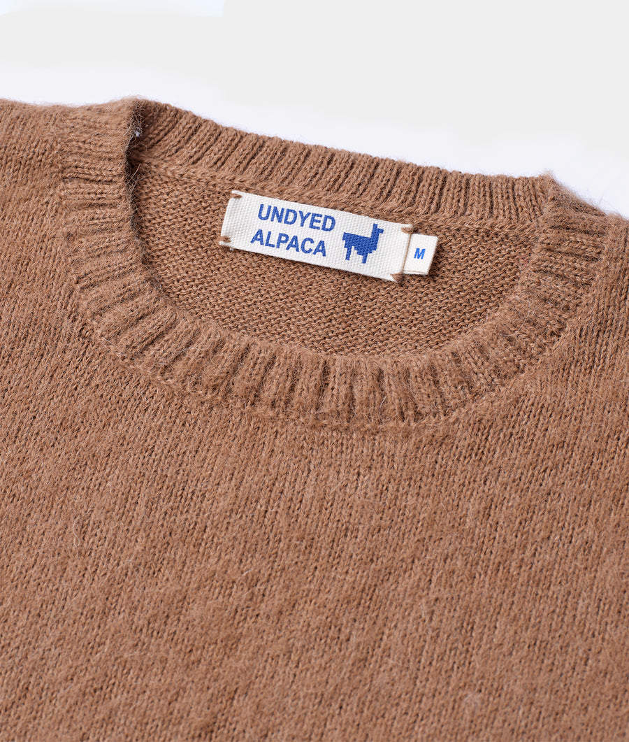 Closeup detail shot of a medium-sized brown undyed alpaca sweater with label - Industry of All Nations
