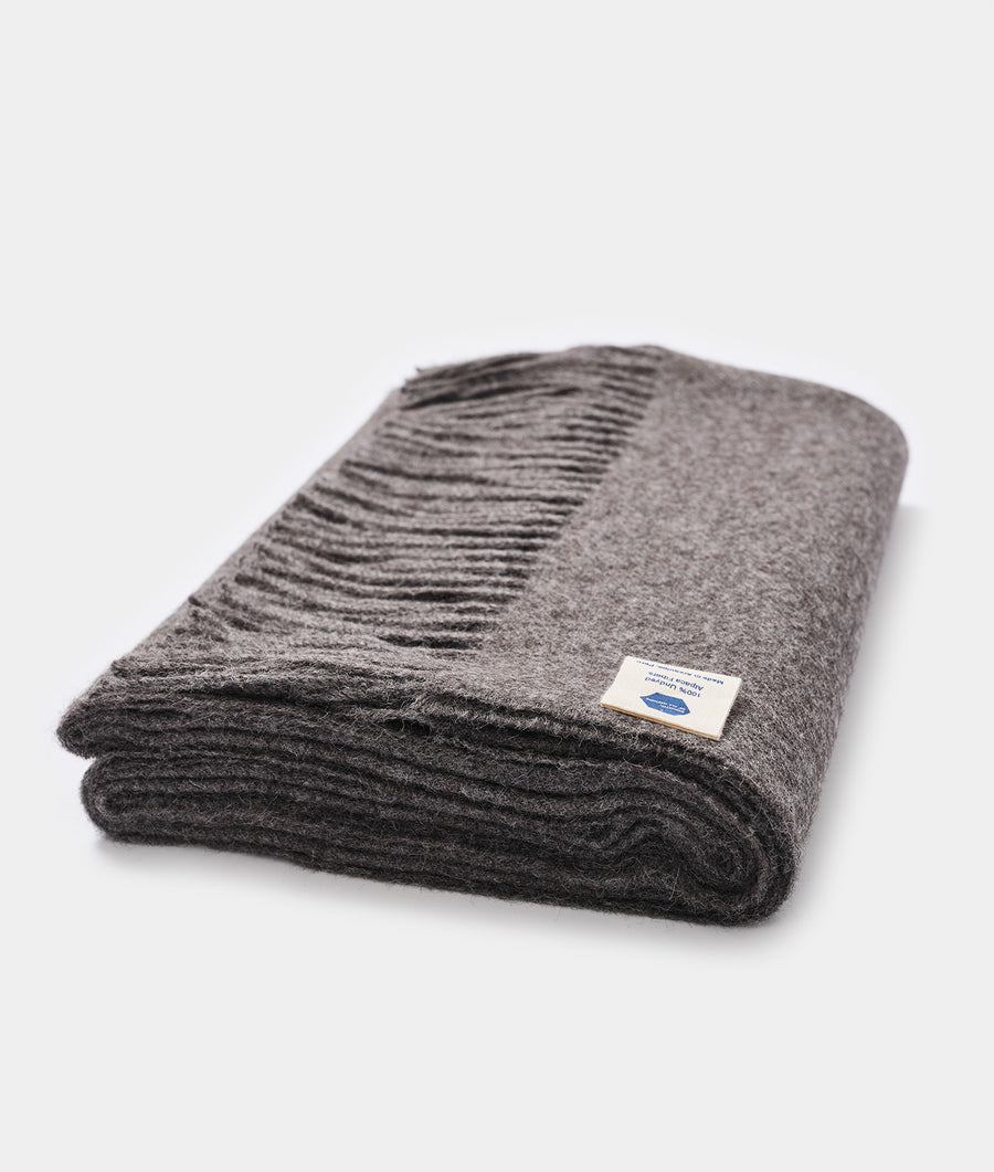 A folded gray wool blanket with a woven texture, displayed in a flat lay - Industry of All Nations