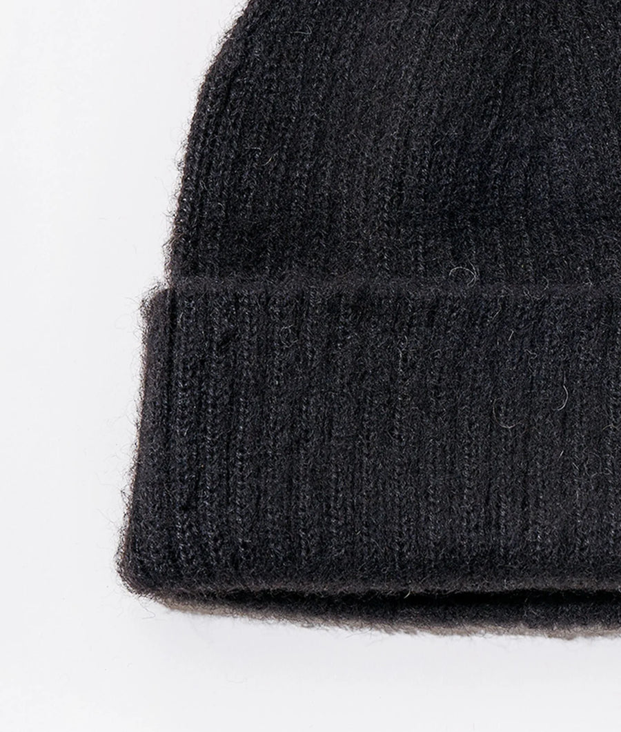 Closeup detail shot of a dark charcoal gray knitted alpaca beanie hat - Industry of All Nations