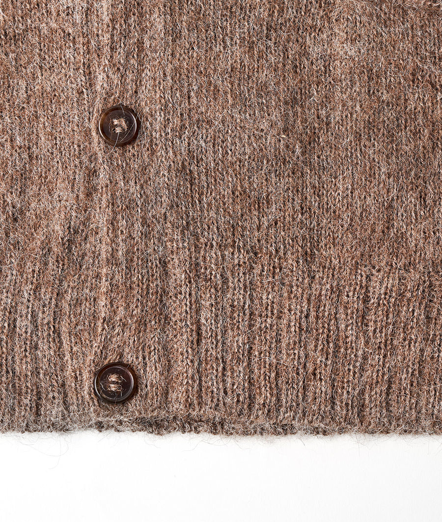 Close-up detail shot of a light brown, knitted wool cardigan with brown buttons - Industry of All Nations