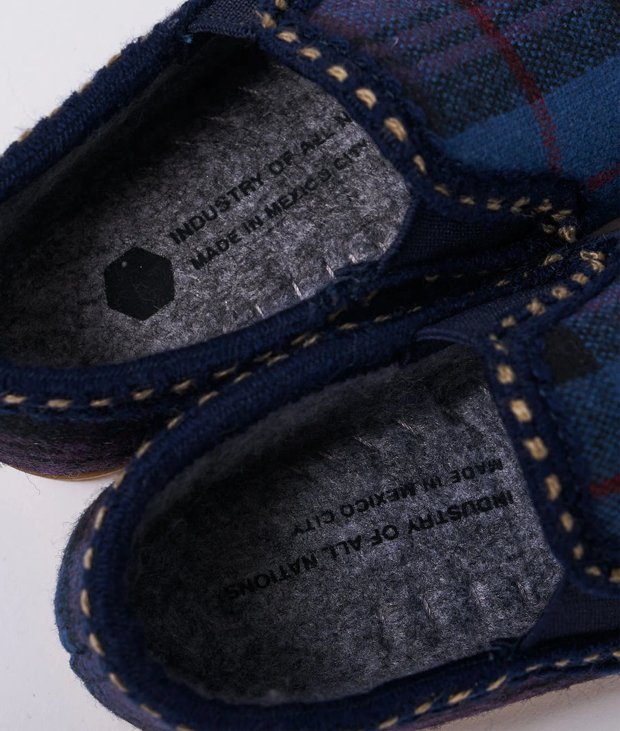 Close-up detail shot of a navy blue knitted sweater with grey trim from Industry of All Nations.