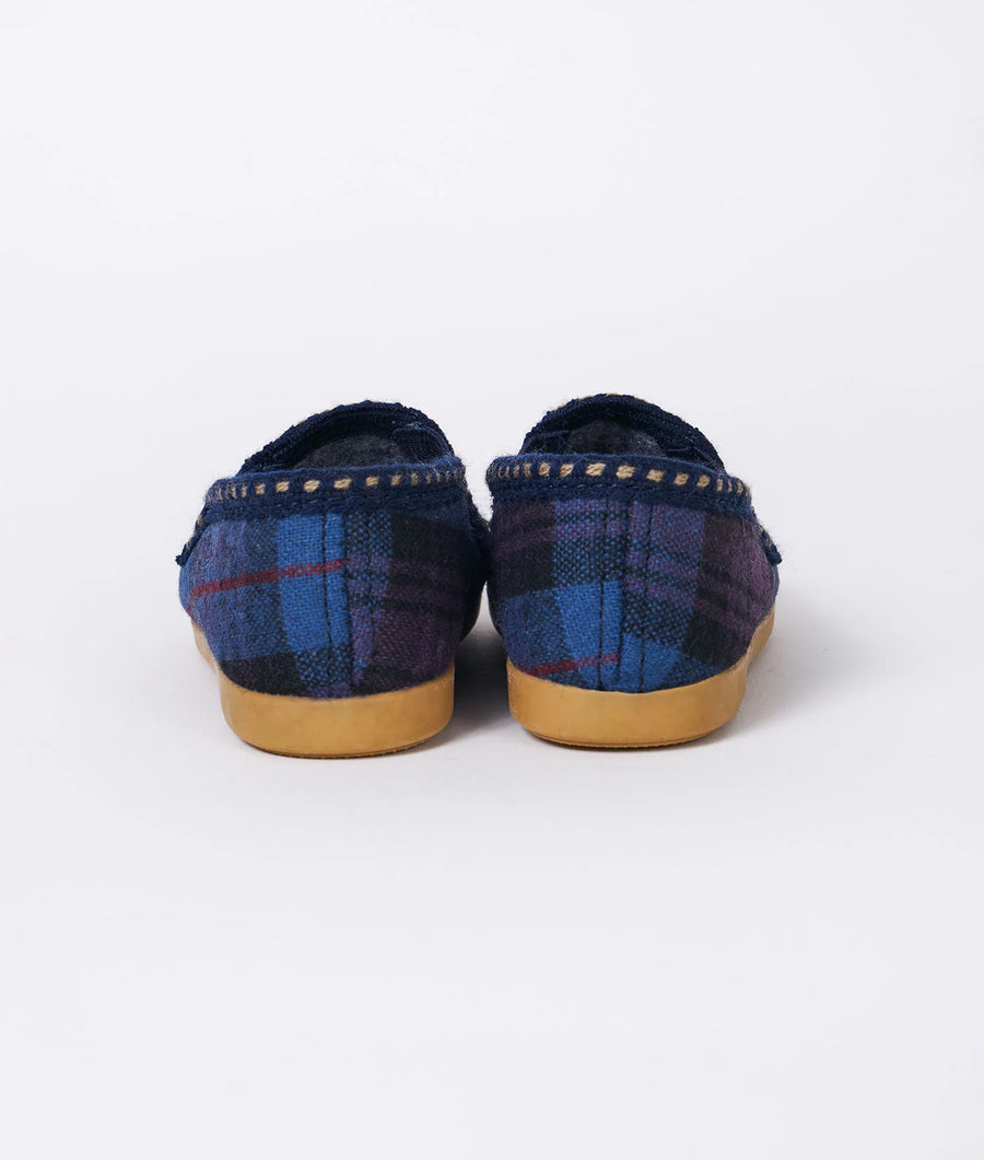 Pair of patterned navy and blue woven slip-on shoes with gum soles, displayed in a flat lay - Industry of All Nations