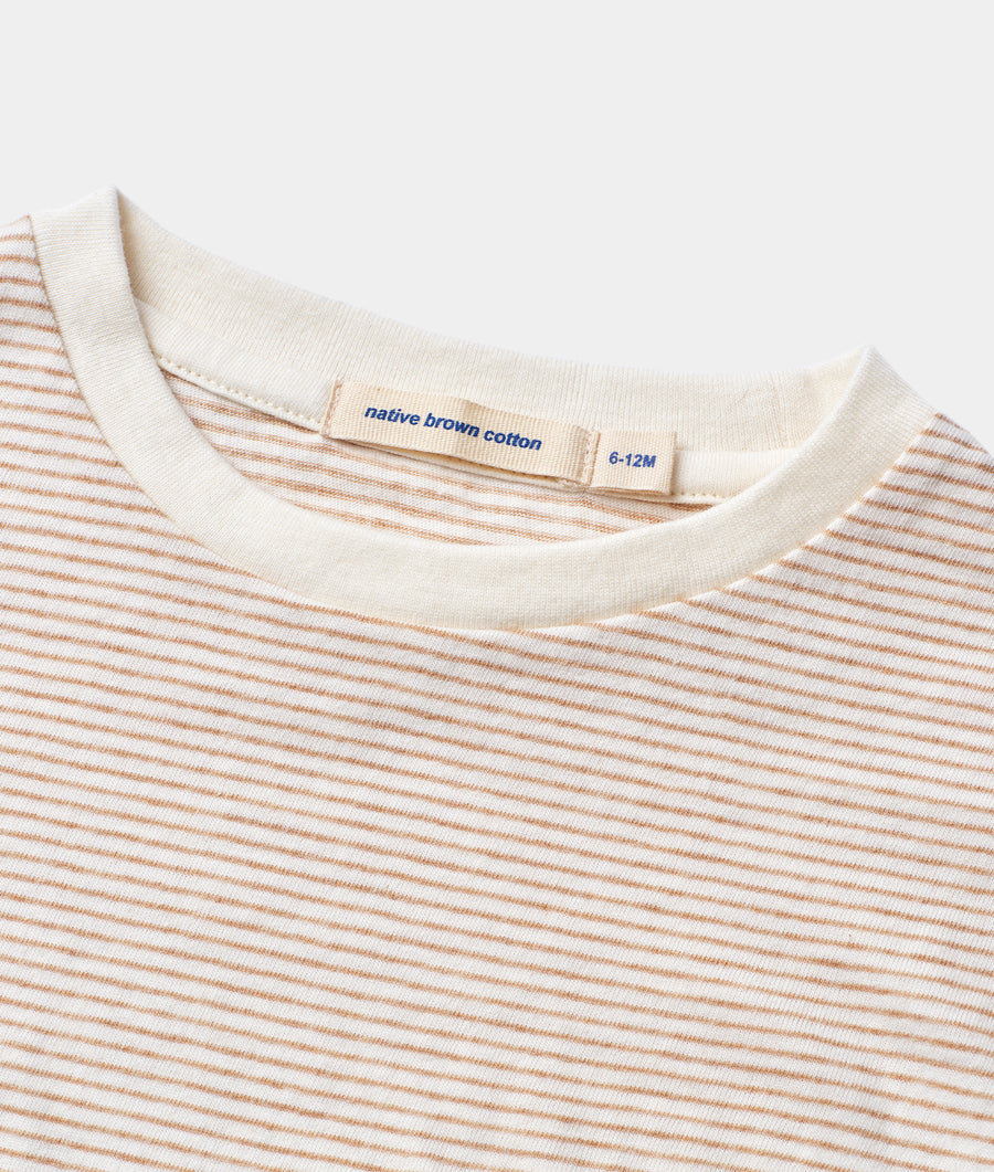 A detail shot of a striped, long-sleeve t-shirt made of native brown cotton, displayed flat - Industry of All Nations