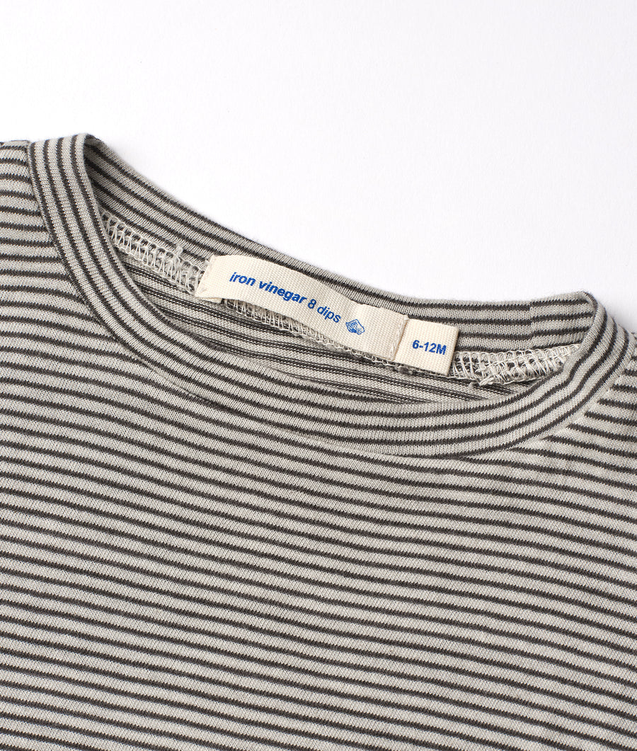 Detail shot of striped long-sleeved shirt with "Iron vinegar & dios" label - Industry of All Nations