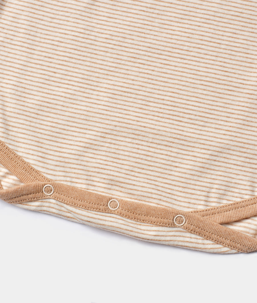 Detail shot of a beige organic cotton shirt with horizontal stripes and snap buttons along the collar - Industry of All Nations