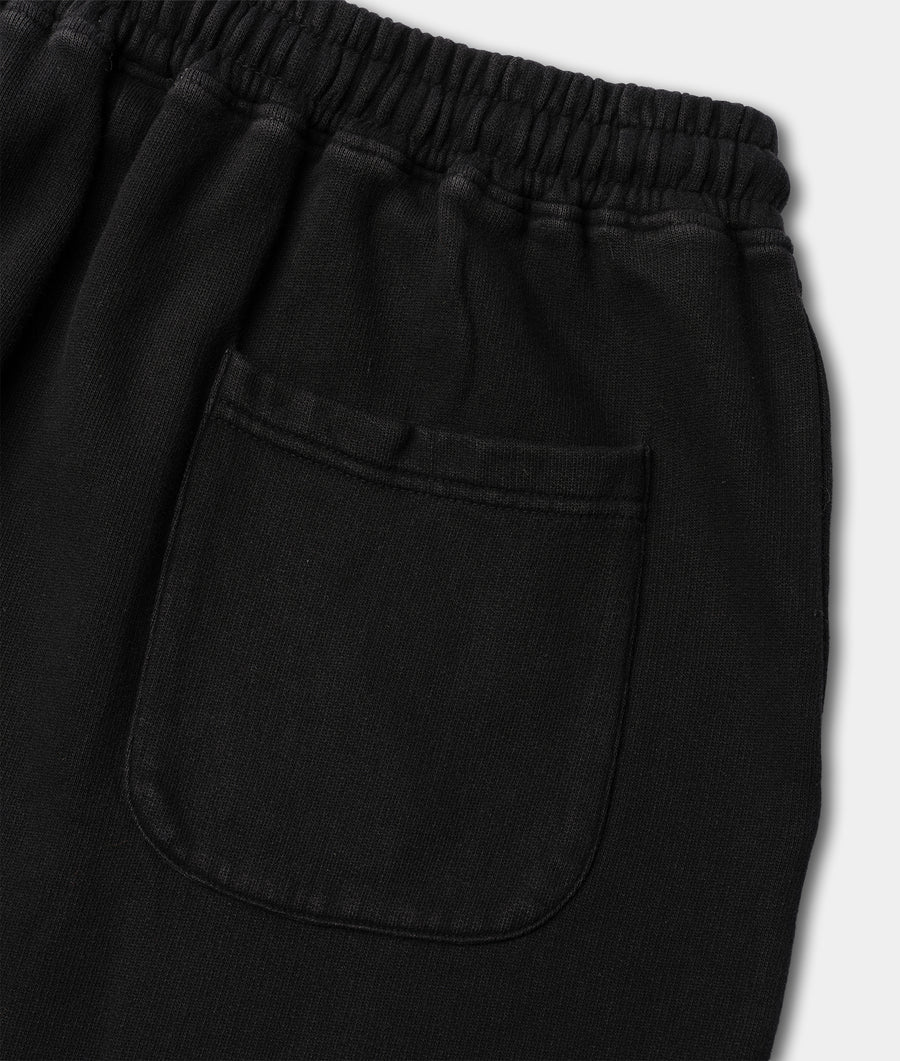 Close-up shot of black cotton shorts with elastic waistband and side pocket - Industry of All Nations