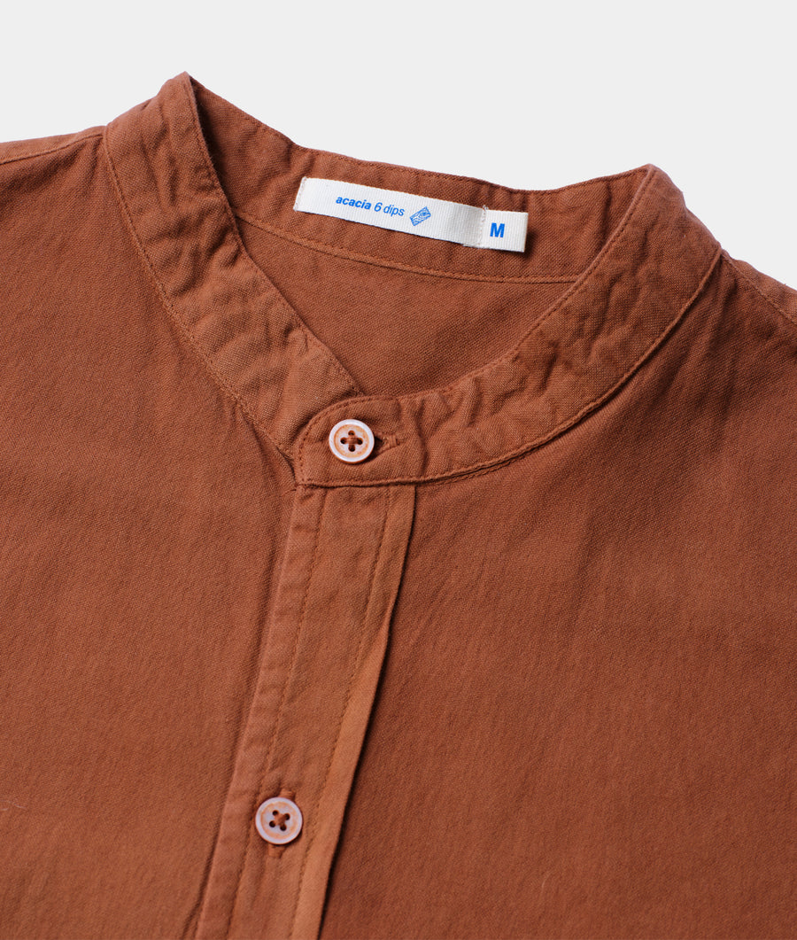 Close-up detail shot of a brown organic cotton button-down shirt from Industry of All Nations.