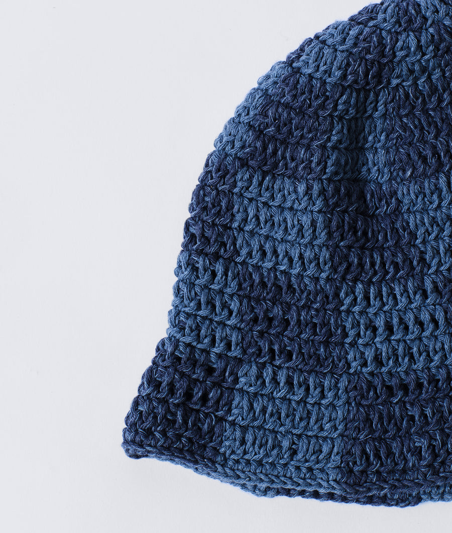 A close-up detail shot of a navy blue crocheted hat - Industry of All Nations