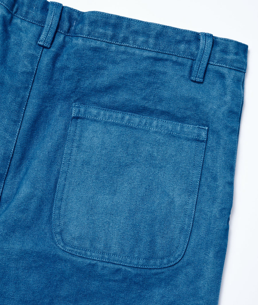 Detail shot of a pair of blue organic cotton pants with a front pocket - Industry of All Nations