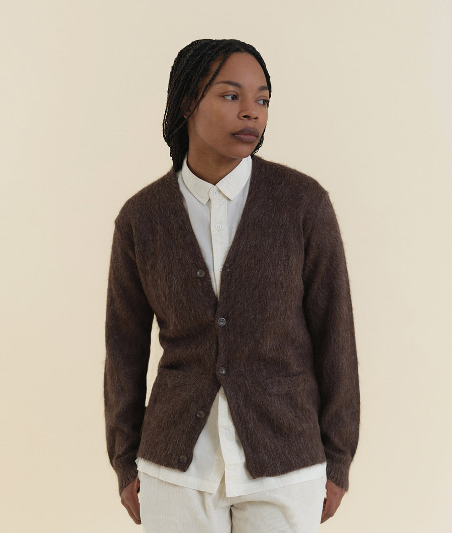 A model wearing a brown fuzzy cardigan over a white button-down shirt - Industry of All Nations