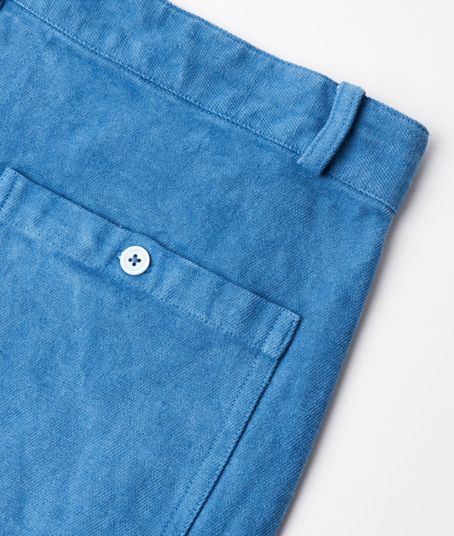 Detailed image of a light blue denim shirt with a single button - Industry of All Nations
