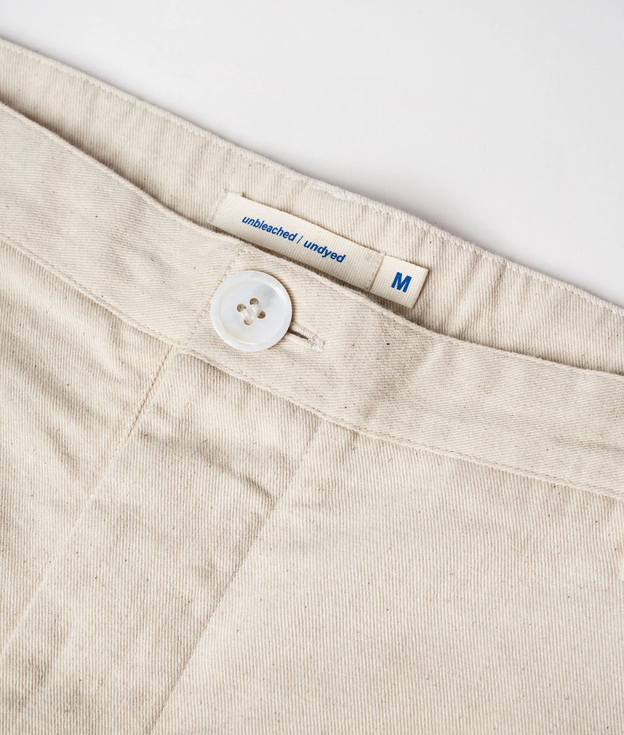 Detail shot of an unbleached and undyed cotton garment with a sewn-in size label - Industry of All Nations