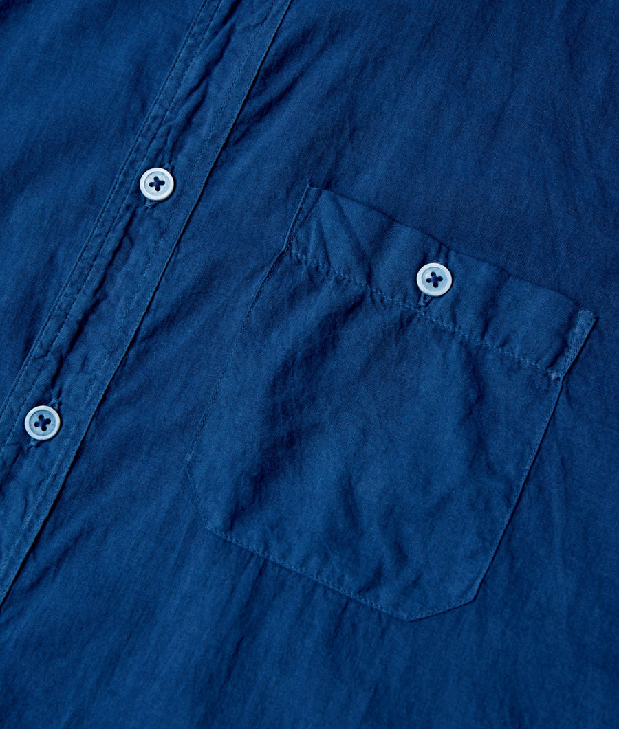 Detail shot of a navy blue button-down shirt with white buttons - Industry of All Nations