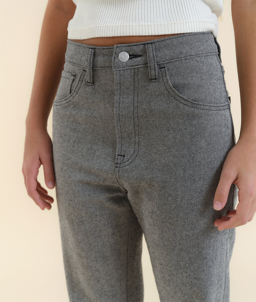 Close-up of the waist and hips of a model wearing gray straight-leg cotton pants with stitching details - Industry of All Nations