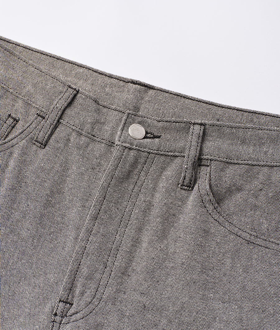 Detail shot of a pair of grey organic cotton trousers with a button closure - Industry of All Nations