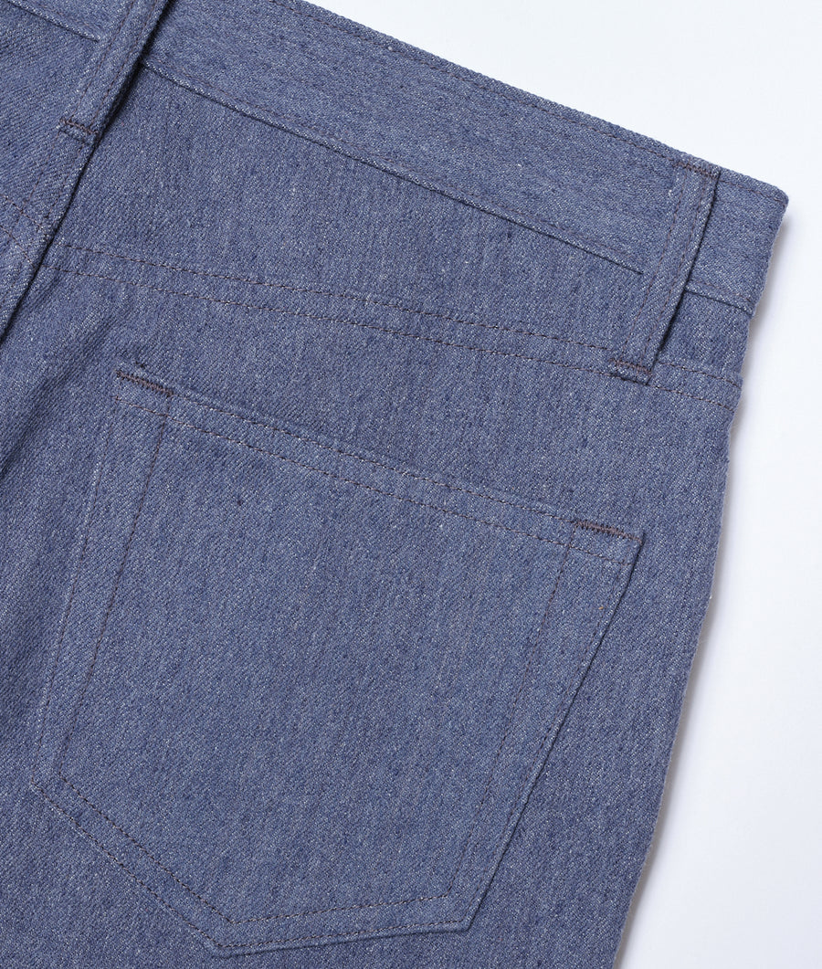 Close-up image of the pockets and stitching details on a pair of dark denim jeans from Industry of All Nations.