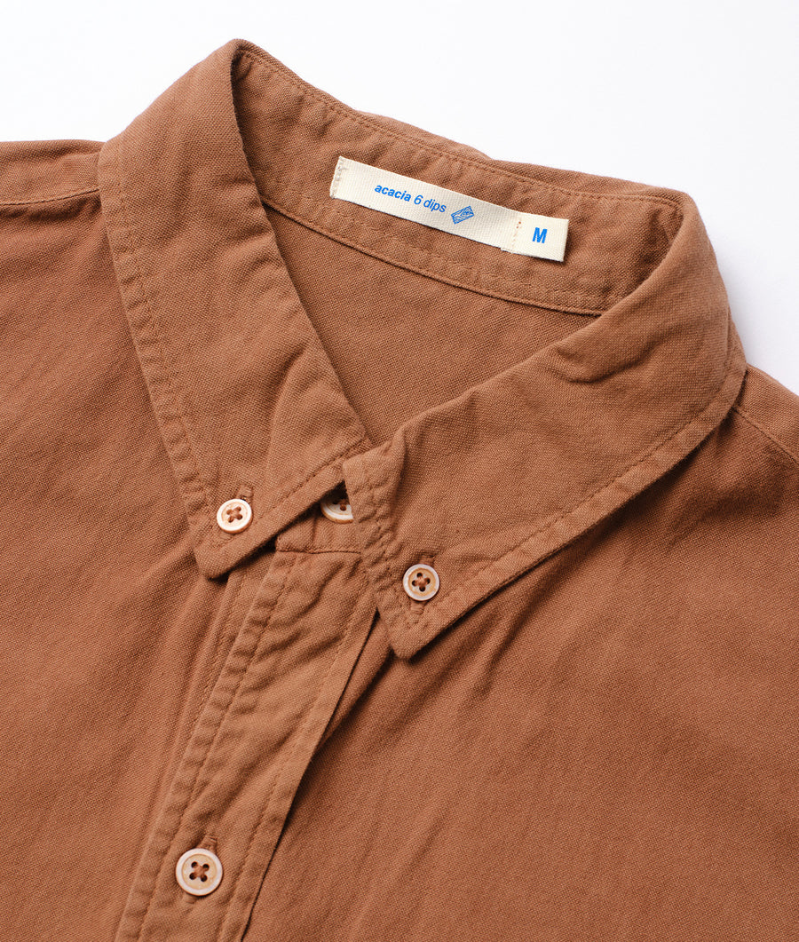 Detailed shot of a brown cotton shirt with Acacia 6 clips label from Industry of All Nations.