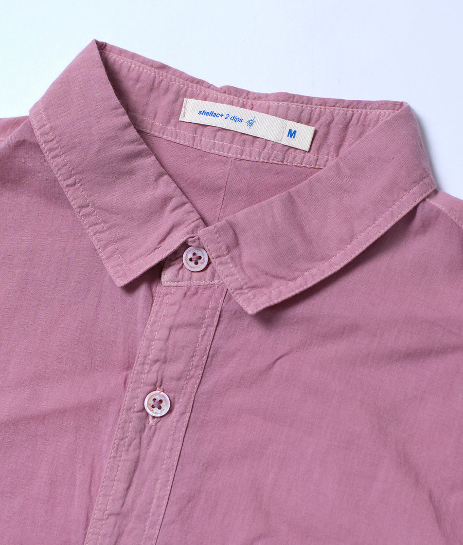 A light pink, medium-sized, button-up shirt with a collar tag displaying "shelter+2 dips" - Industry of All Nations
