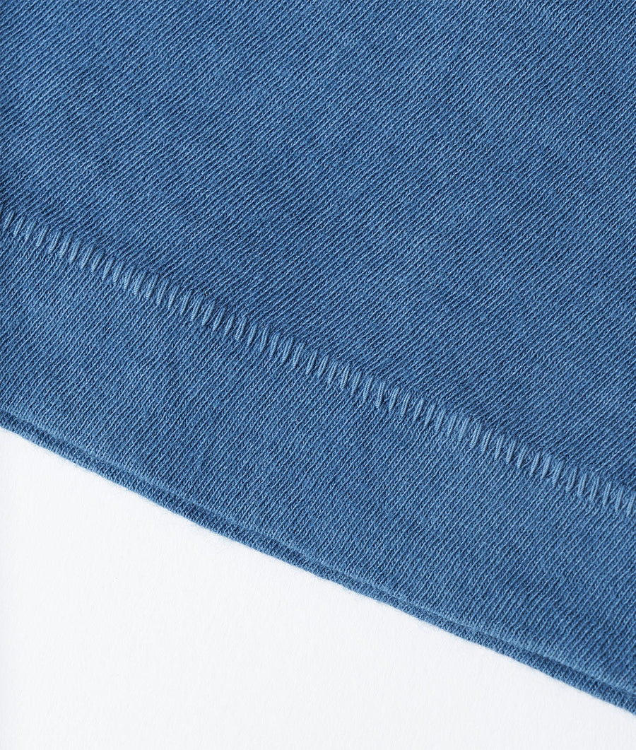 Close up detail shot of a blue organic cotton scarf with a textured diagonal pattern - Industry of All Nations
