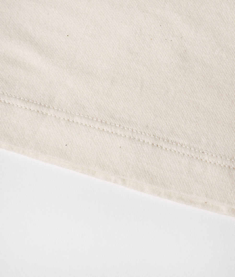 Detail shot of beige organic cotton t-shirt - Industry of All Nations