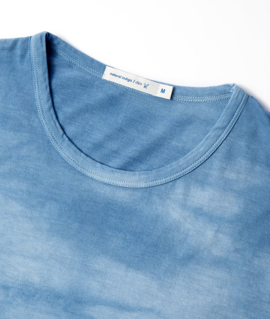 Blue natural indigo tie-dye t-shirt laid flat, showing the soft, woven texture and vibrant color - Industry of All Nations