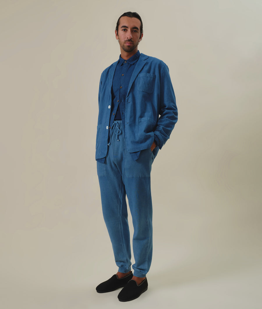 Man wearing a full blue linen suit with a button-down shirt - Industry of All Nations