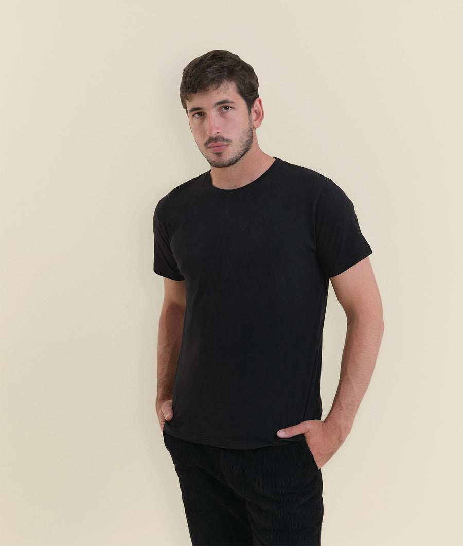 Portrait of a man wearing a black t-shirt from Industry of All Nations.