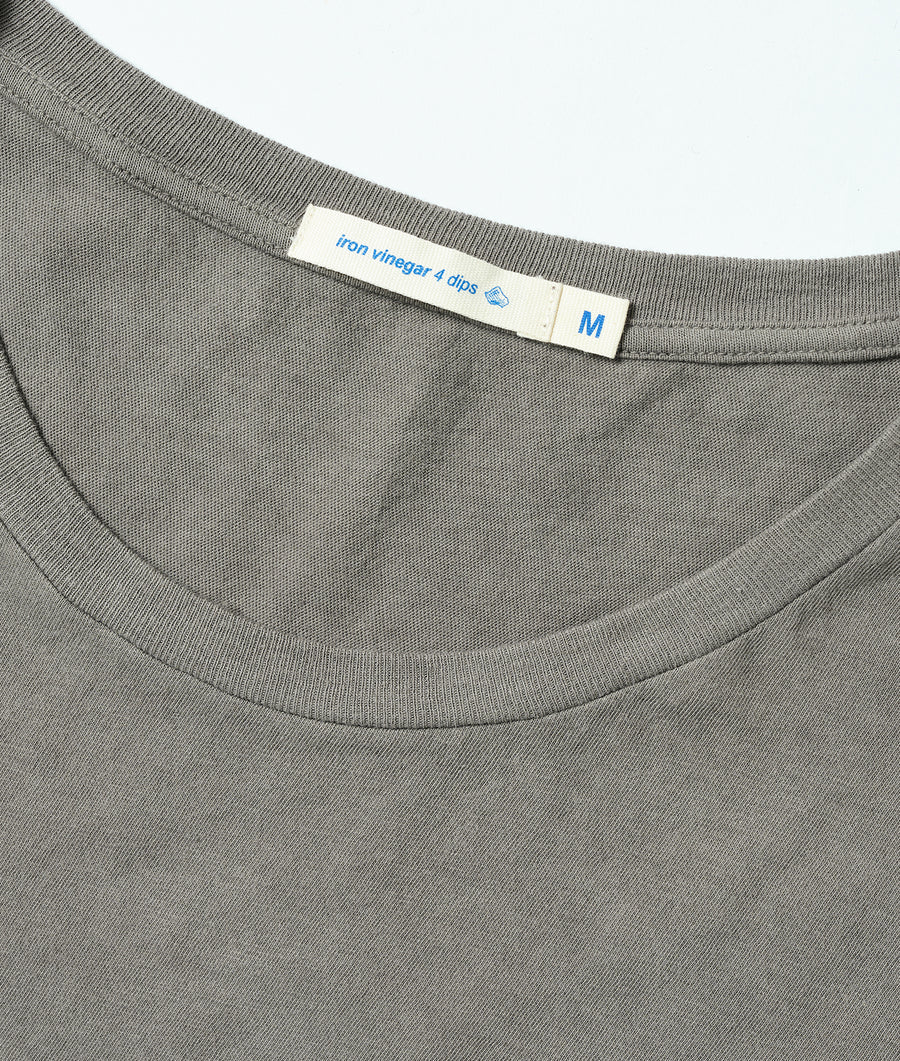Detail shot of a medium-sized grey t-shirt with an "iron vinegar 4 dips" label - Industry of All Nations
