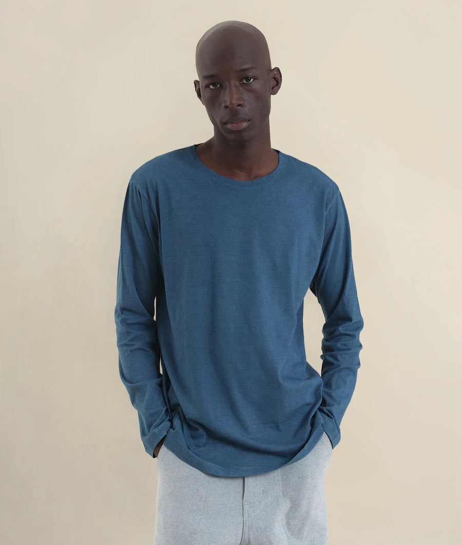 Blue long-sleeve t-shirt worn by male model on neutral background - Industry of All Nations