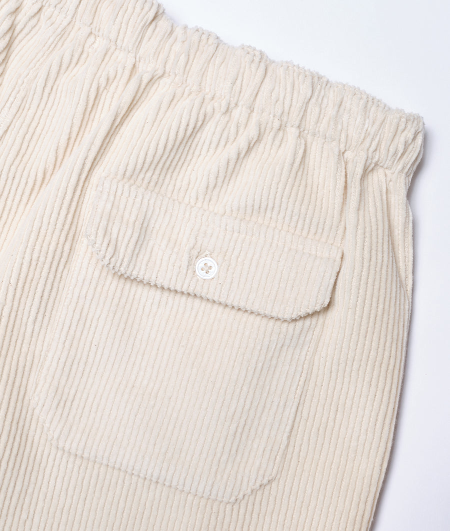 Closeup detail shot of ivory-colored corduroy pants with front pocket - Industry of All Nations
