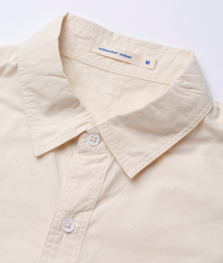 Close-up shot of a beige, unbleached and undyed cotton shirt - Industry of All Nations