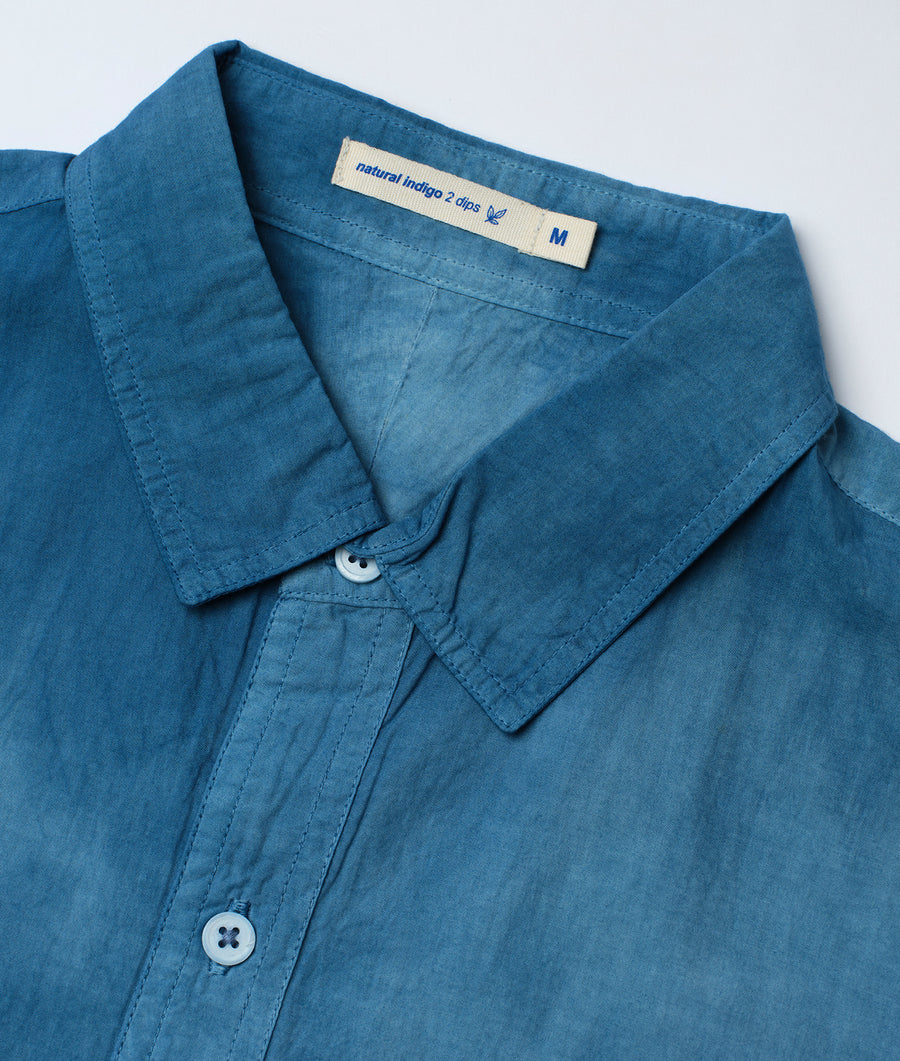 Closeup of a blue denim work shirt with natural indigo color and "natural indigo 2 clips" label - Industry of All Nations