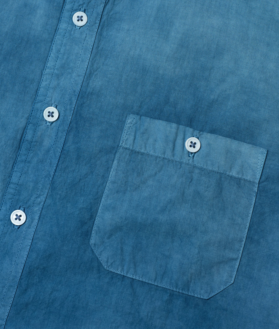 Detailed shot of a teal blue button-up shirt with buttons and a chest pocket - Industry of All Nations