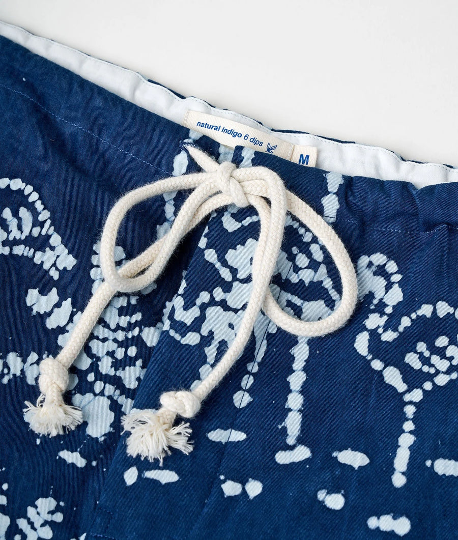 Detail shot of a blue and white patterned organic cotton swimsuit with a drawstring waist - Industry of All Nations