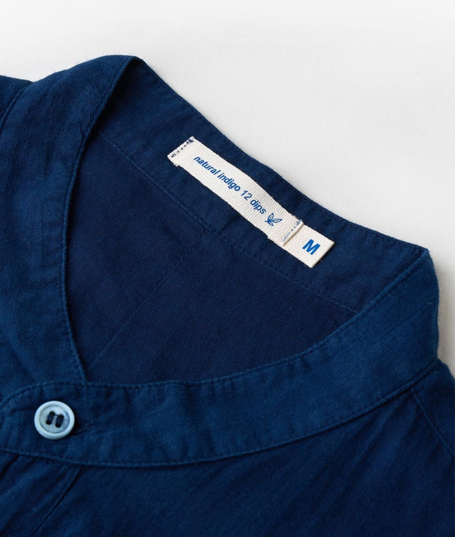 Flat lay detail shot of a navy blue garment with a natural indigo dye label - Industry of All Nations