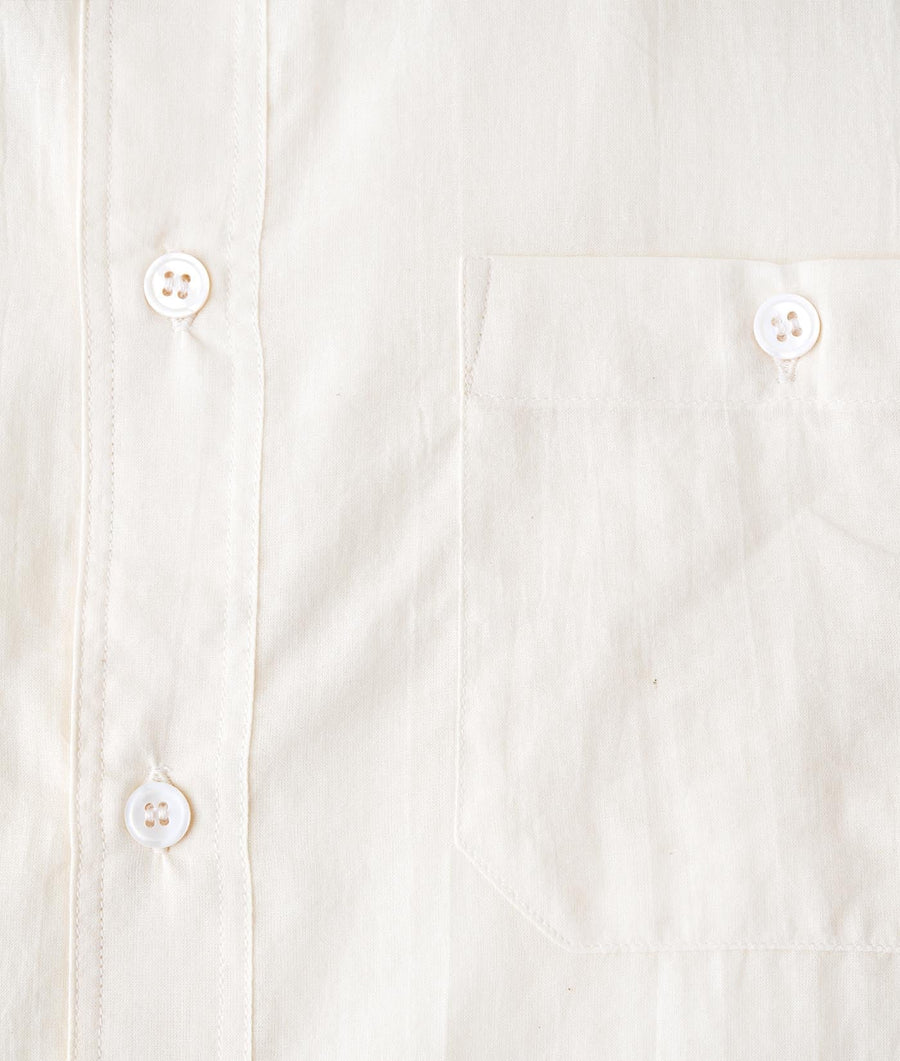 White cotton button-down shirt displayed as a detail shot showing the buttons and fabric texture - Industry of All Nations