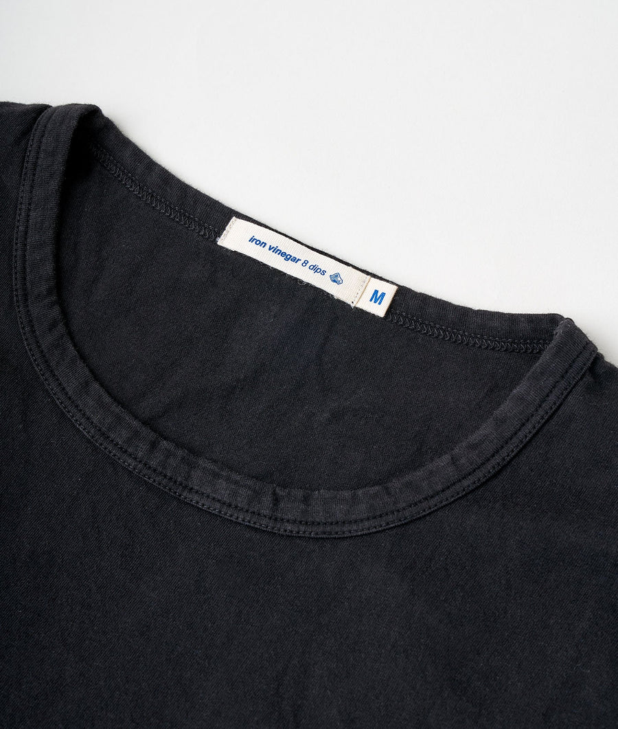 Close-up detail shot of a black cotton t-shirt with the brand tag 'Iron winger 8-dies' visible - Industry of All Nations