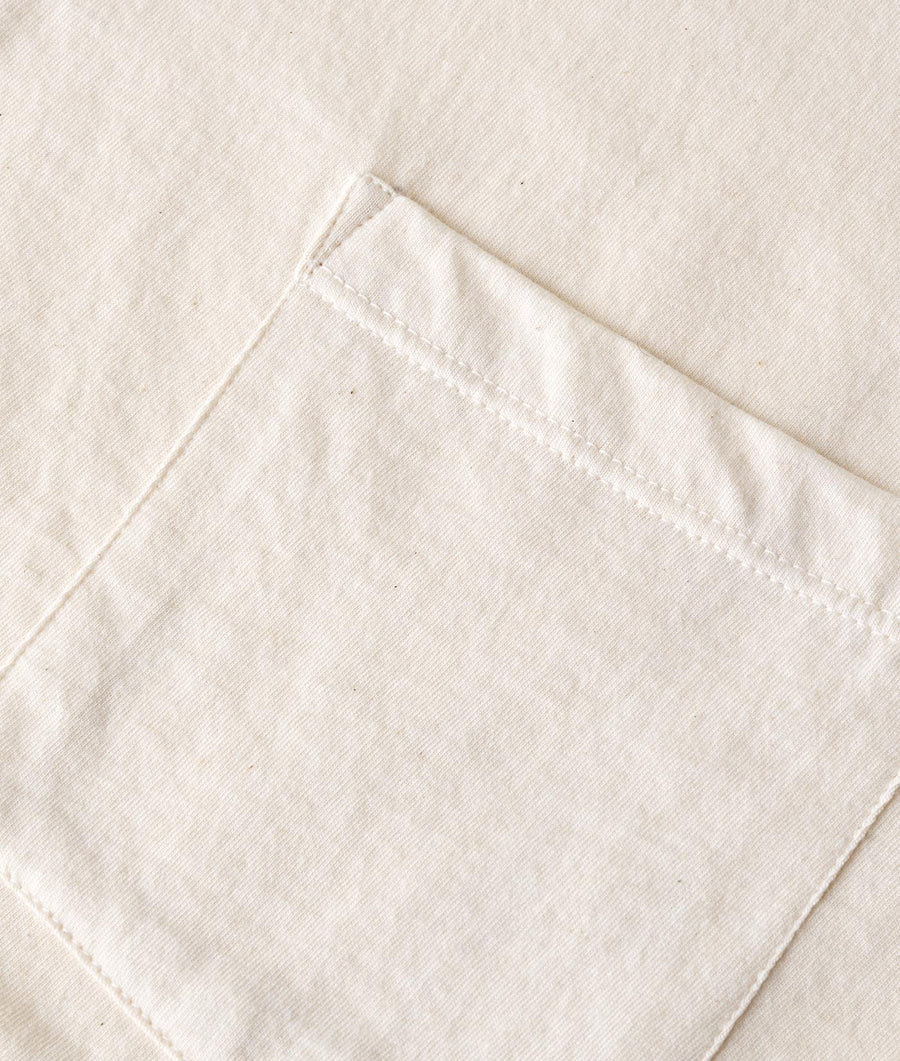 Close-up detail shot of a white organic cotton garment - Industry of All Nations