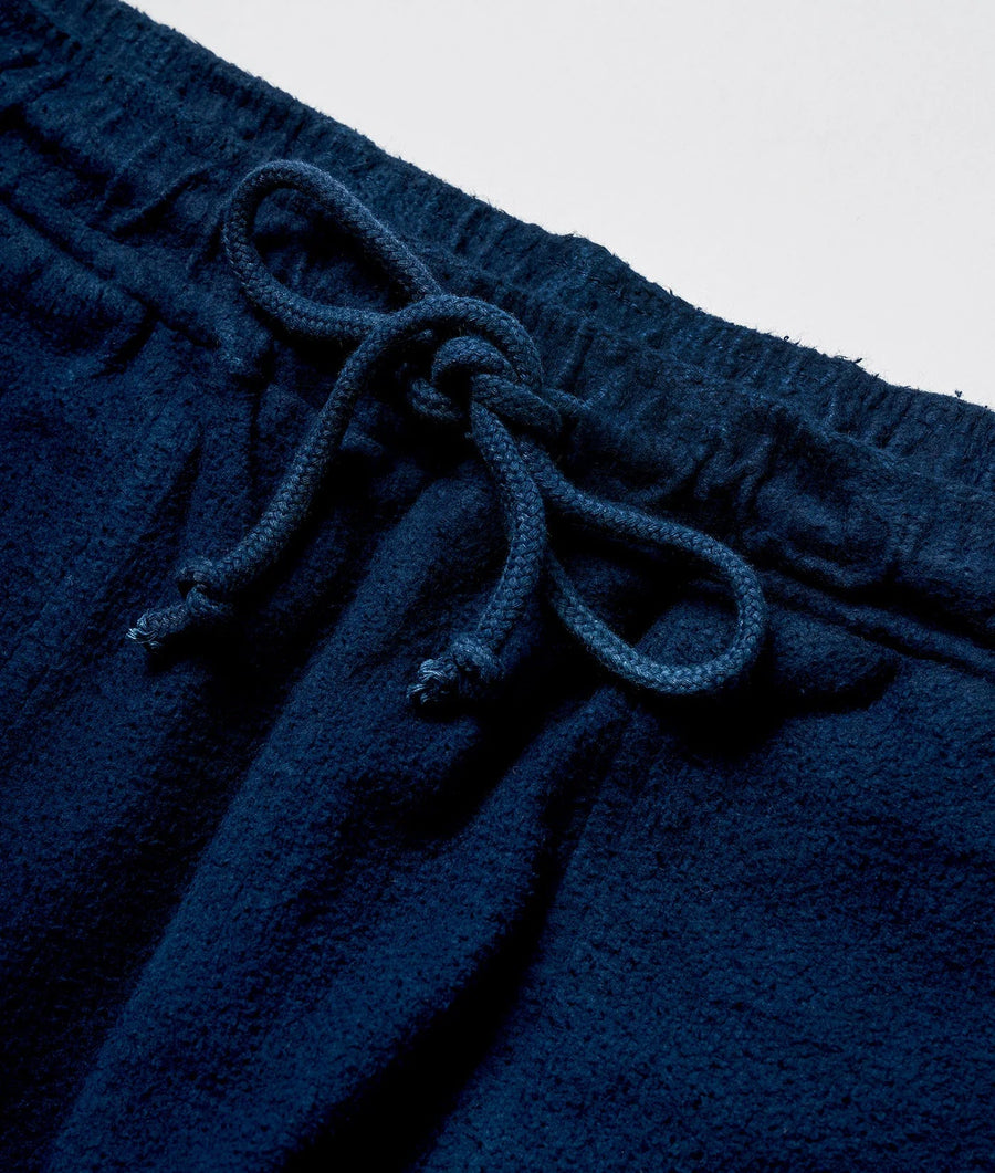 Close-up detail shot of a navy blue organic cotton drawstring shorts with knotted tie waistband - Industry of All Nations